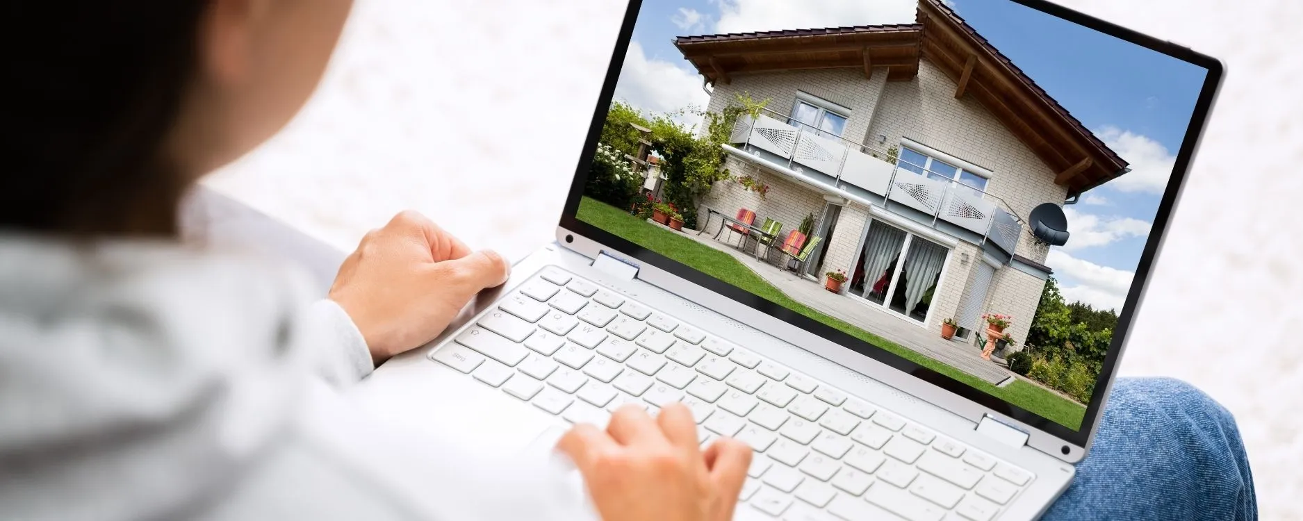 Home buyer browsing homes for sale on a laptop